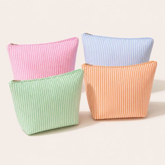 Cute seersucker travel makeup bag in pink blue green and orange for cute girls trip, mothers day, birthday, valentines day gift. Adorable cute and stylish makeup travel pack.
